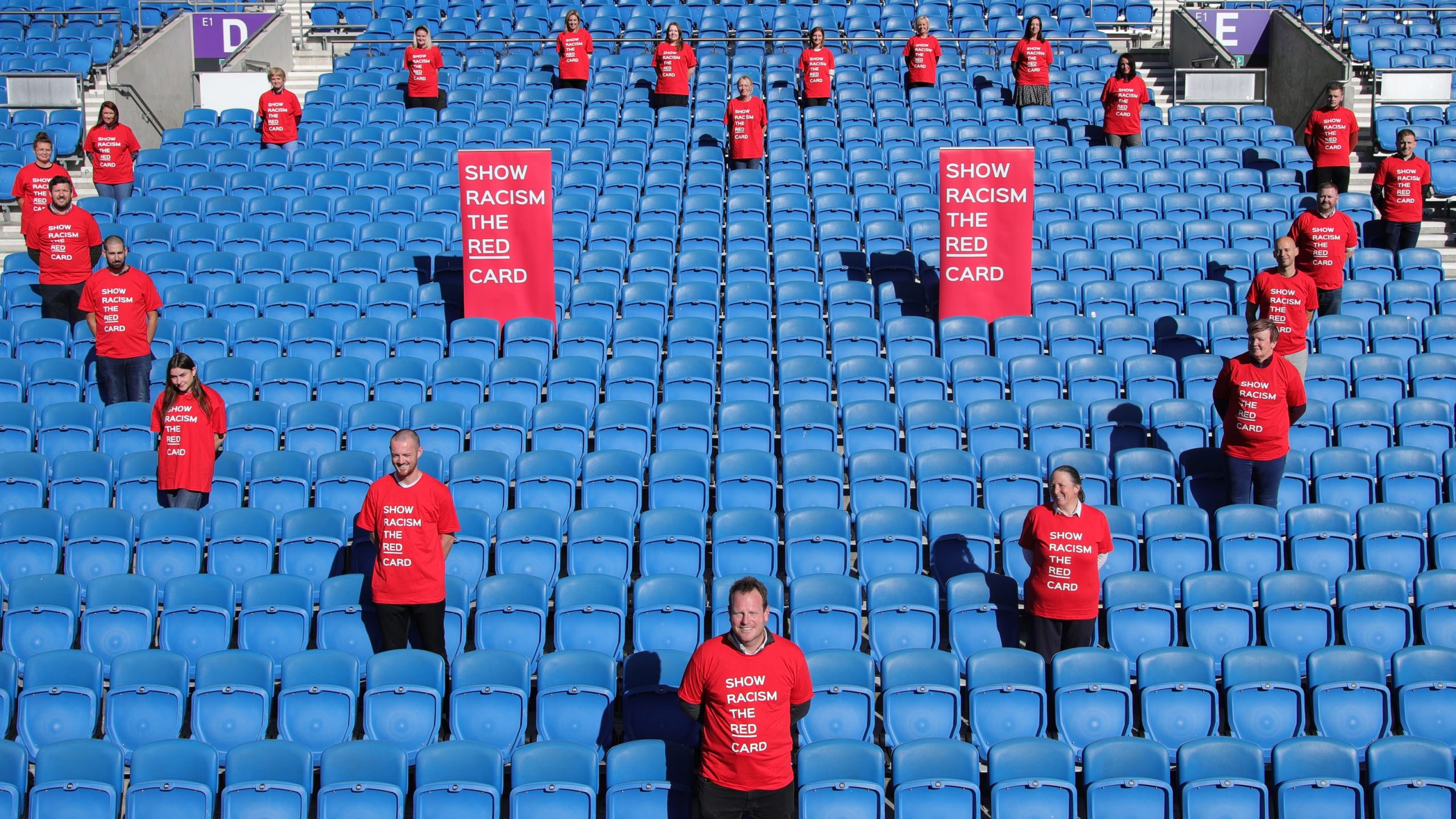people in the stadium seats in a shape of heart