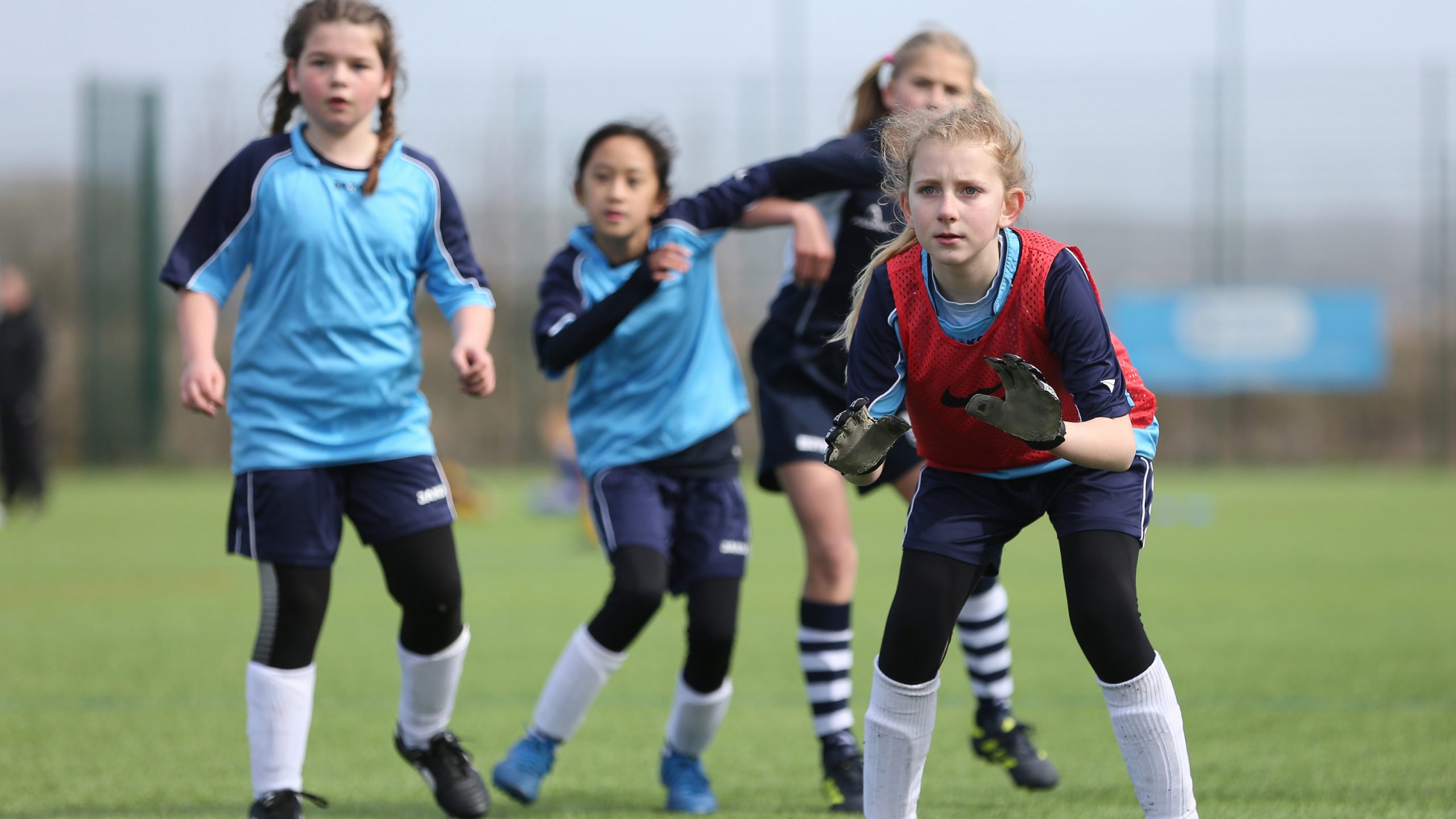 girl goalkeeper and other girls playing